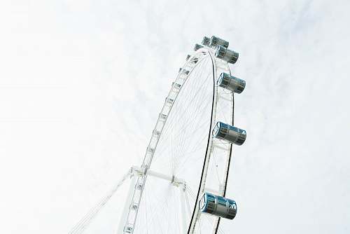 amusement park low angle photography of ferris wheel under white sky leisure activities